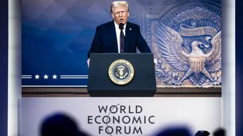 EPA-EFE/REX/Shutterstock Trump appeared at Davos remotely last year, just a few days after his inauguration
